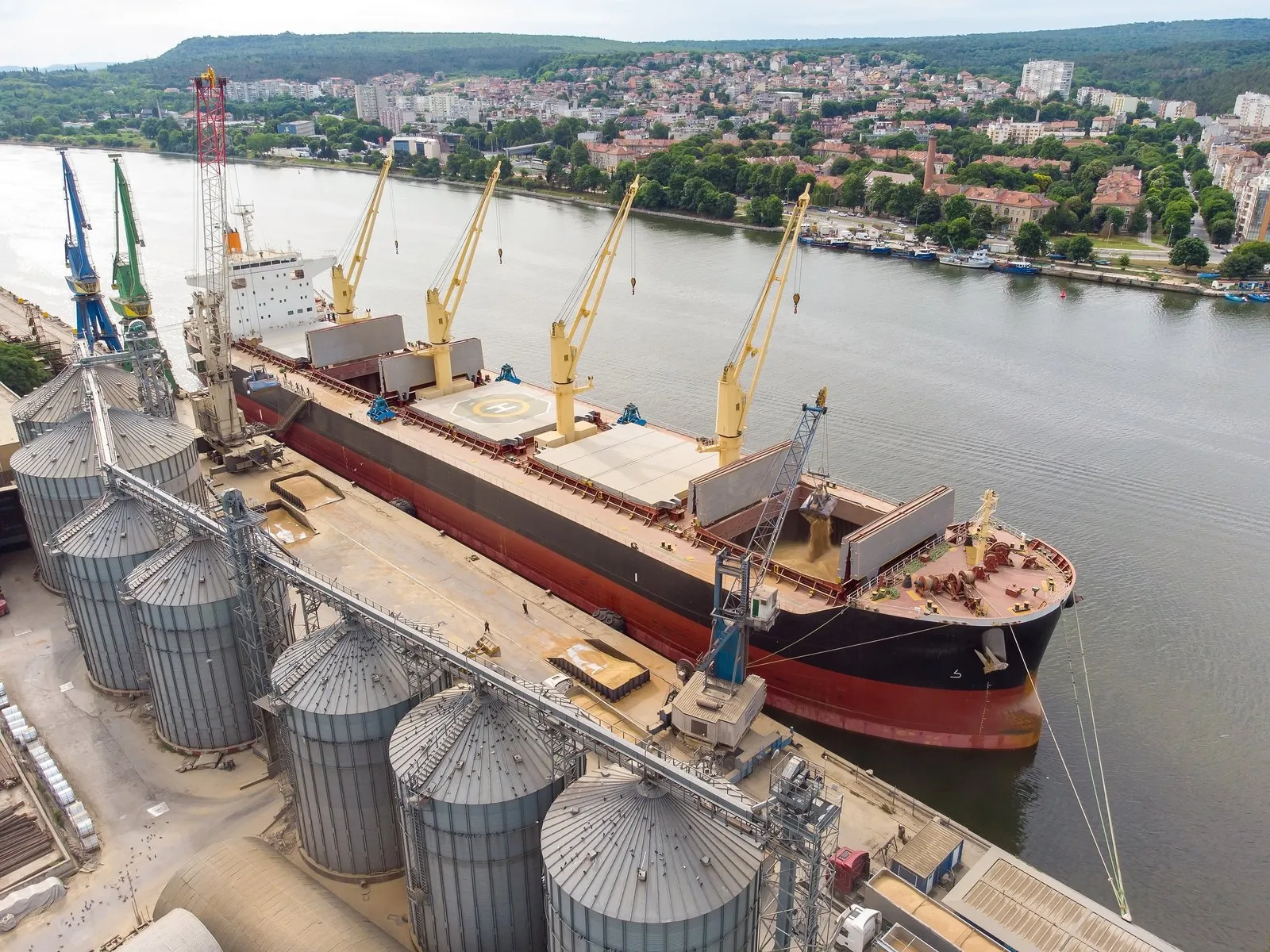 Dry-bulk carrier loading at a grain terminal.