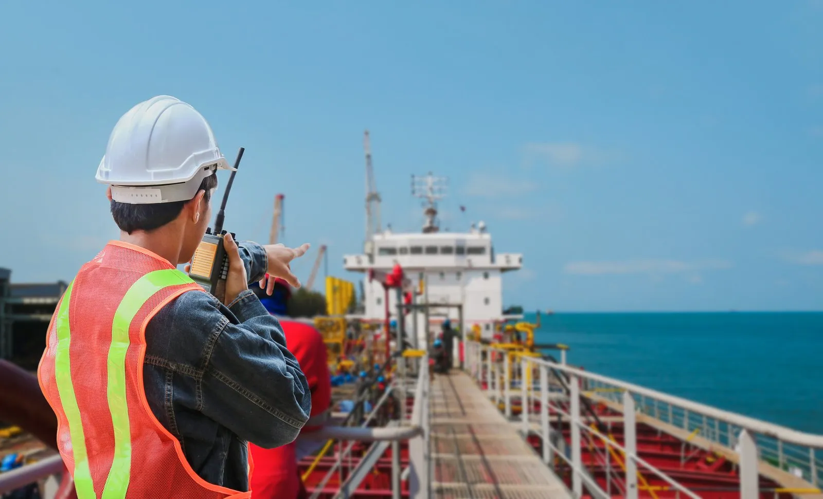 Port agent communicating by radio aboard a vessel.